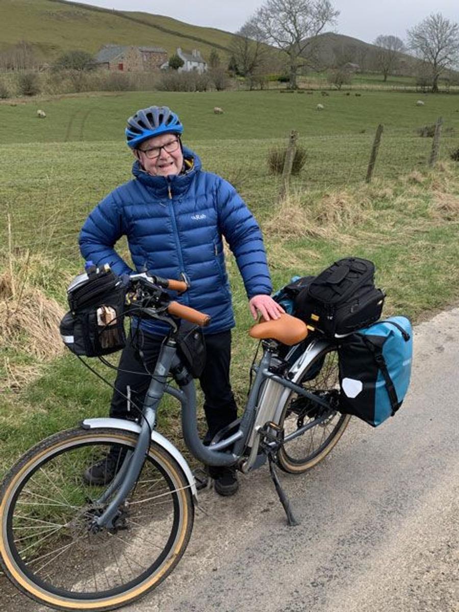 Image of rider standing next to Juicy Classic electric bike